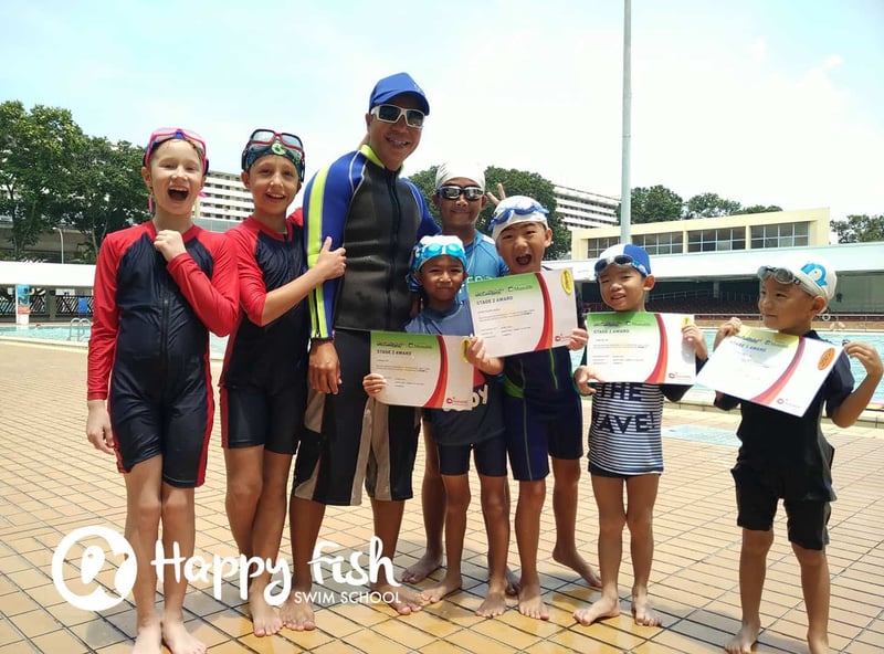 Group photo of students of Happy Fish Swim School holding their certificates