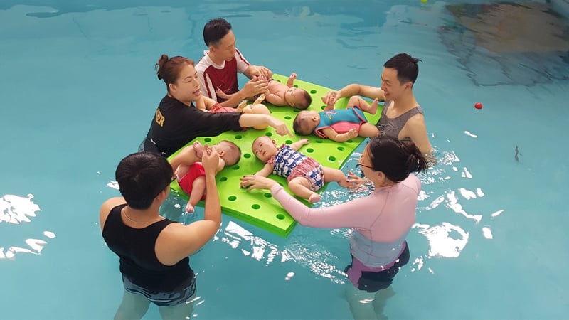 Parents exposing infants to water and swimming