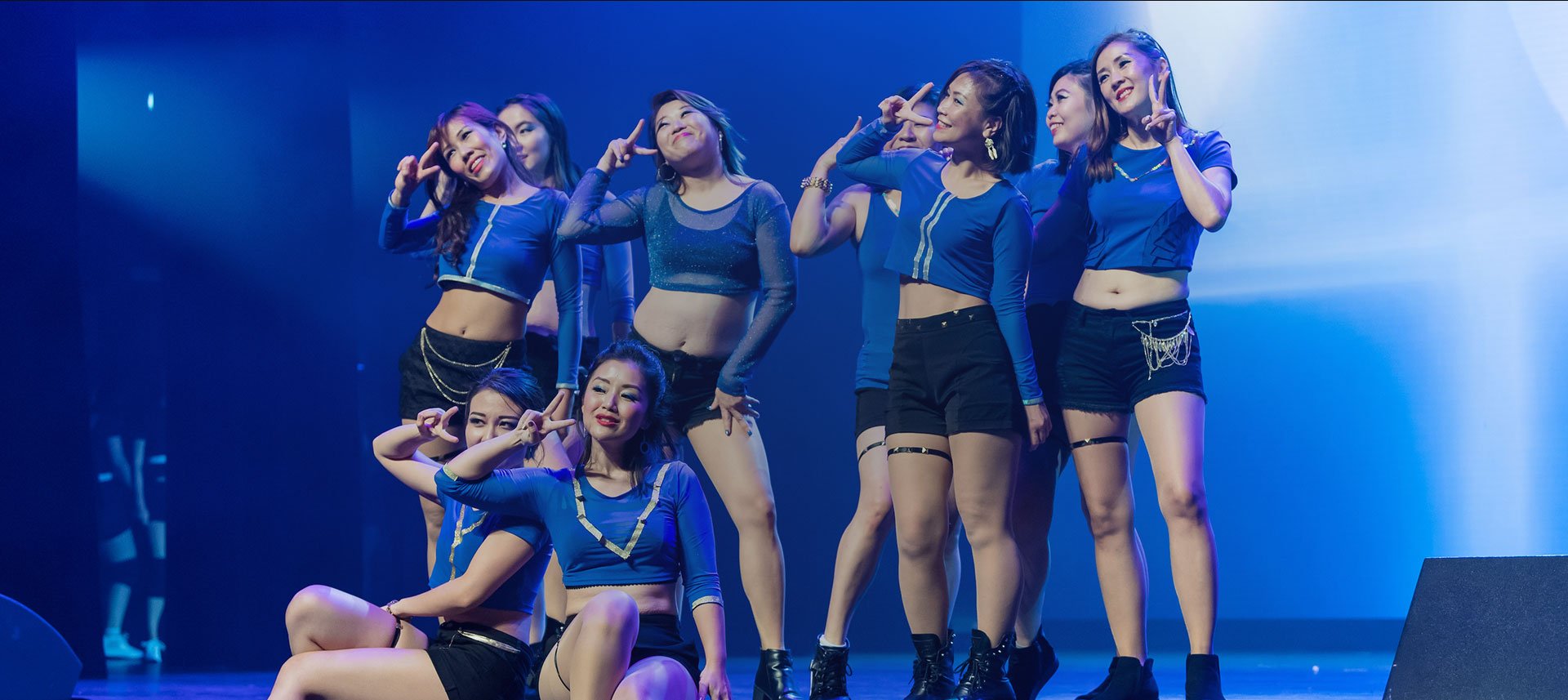 A group of dancers striking a pose on stage