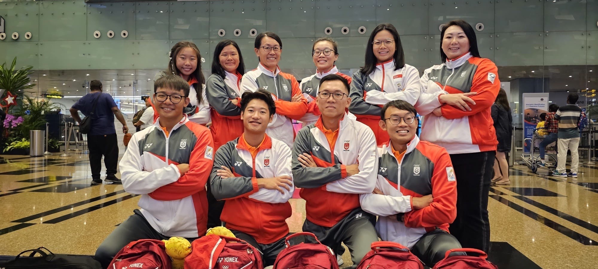 Pacific Swim Team group photo at airport