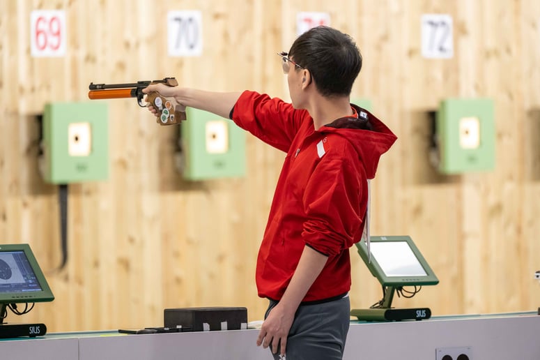 Paralympian Daniel Chan takes aim at the shooting range with his pistol.