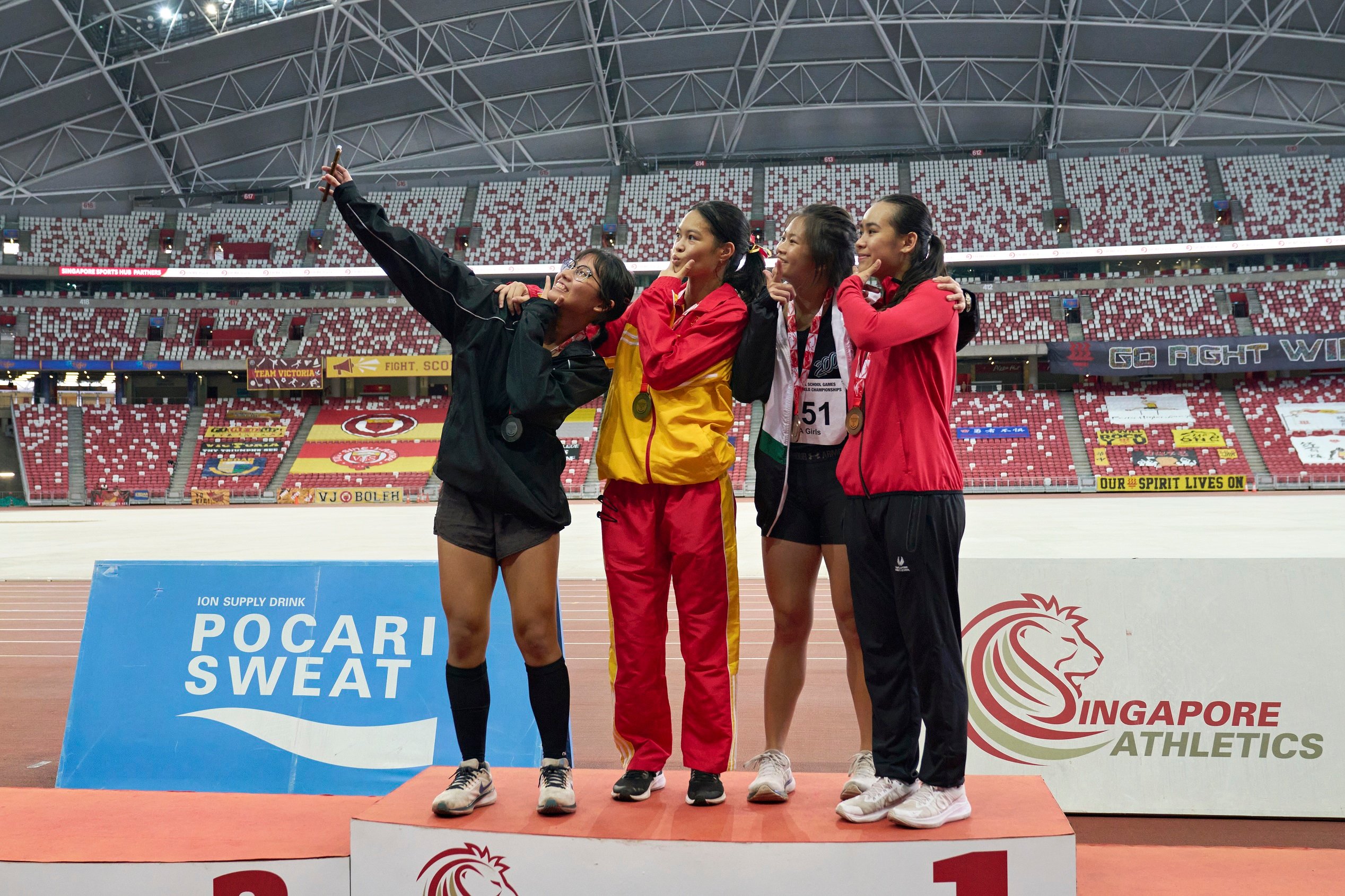 2023-04-28 NSG T&F Championships Photo by Eric Koh, A Div Girls 100m Victory Ceremony (From L) Tan Yi Han Ashley (VJC 2nd) Goh En Ya Eleana (HCI 1st) Lee Woon Yen Meredith (HCi 3rd) Samantha Theresa Orte (SSP 4th) 