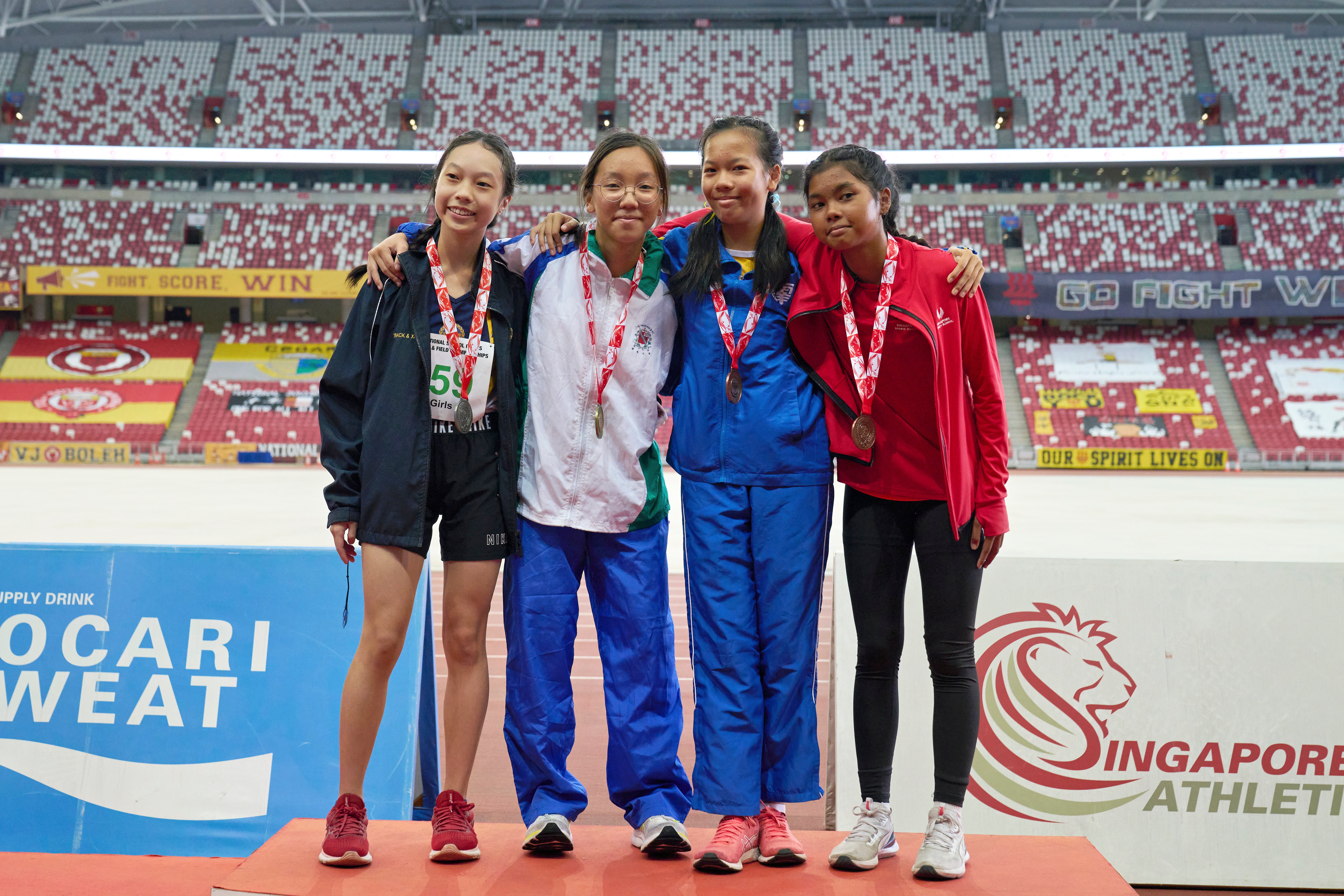 2023-04-28 NSG T&F Championships Photo by Eric Koh, C Div Girls 100m Victory Ceremony, (From L)  Alexa Tan Liyi(MGS 2nd), Teh Xin Nio Charlotte (SNG 1st), Heather Tan Rae Qi(CG 3rd) and Tan Ying Tong Shannon(CG 4th