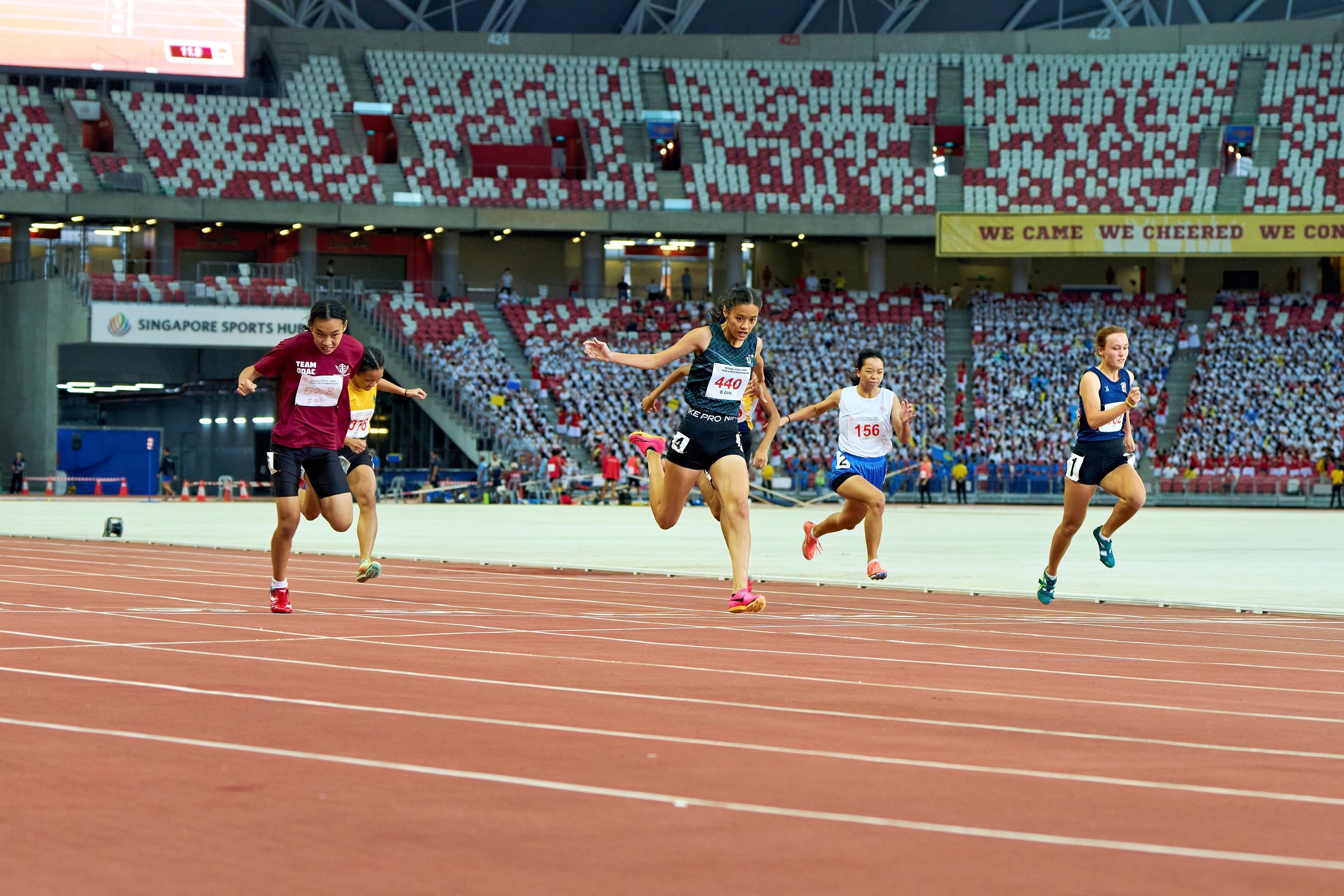 2023-04-28 NSG T&F Championships Photo by Eric Koh, Lim Yee Chern Clara (Bib no 440) finishes her race with a powerful run to claim the Gold medal  for B Div Girls 100m final DSC05798