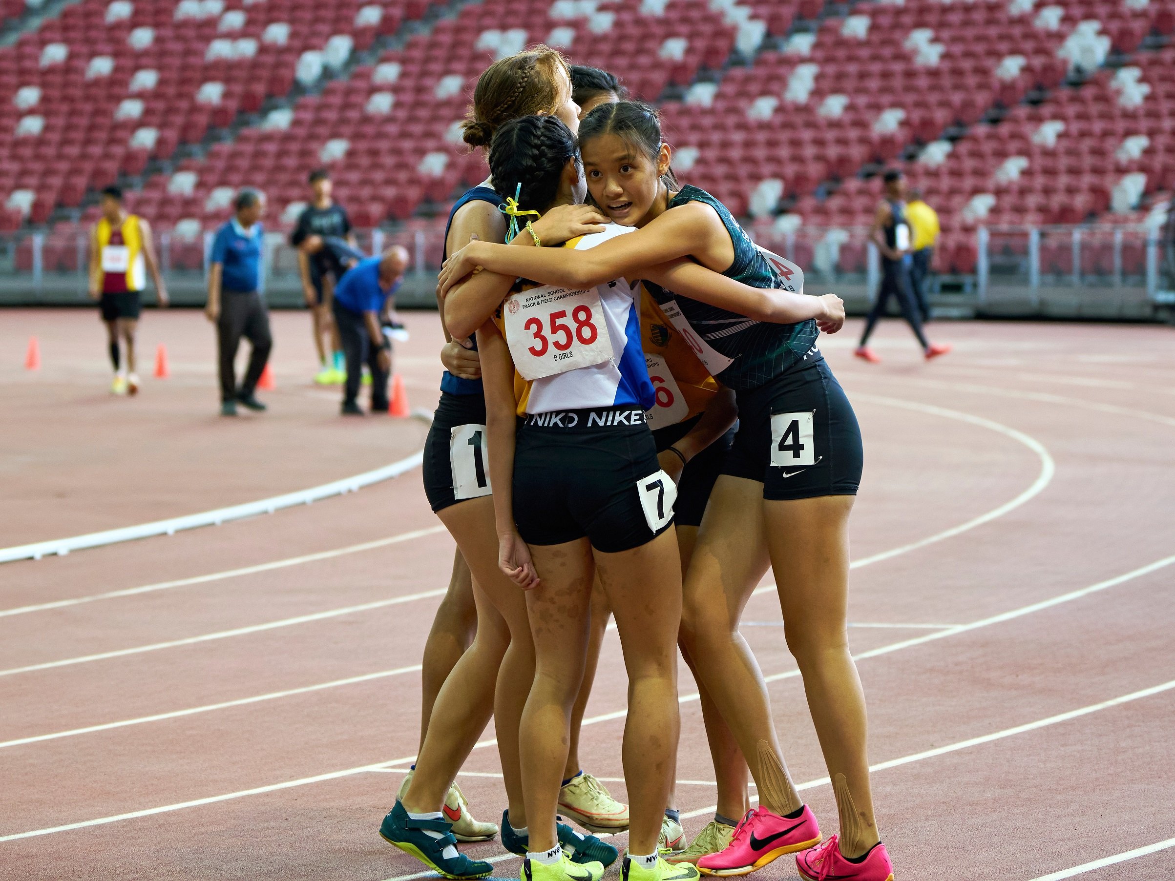 2023-04-28 NSG T&F Championships Photo by Eric Koh, Runners congratulate Lim Yee Chern Clara(R) for her performance at the end of B Div Girls 100m final DSC05823 1