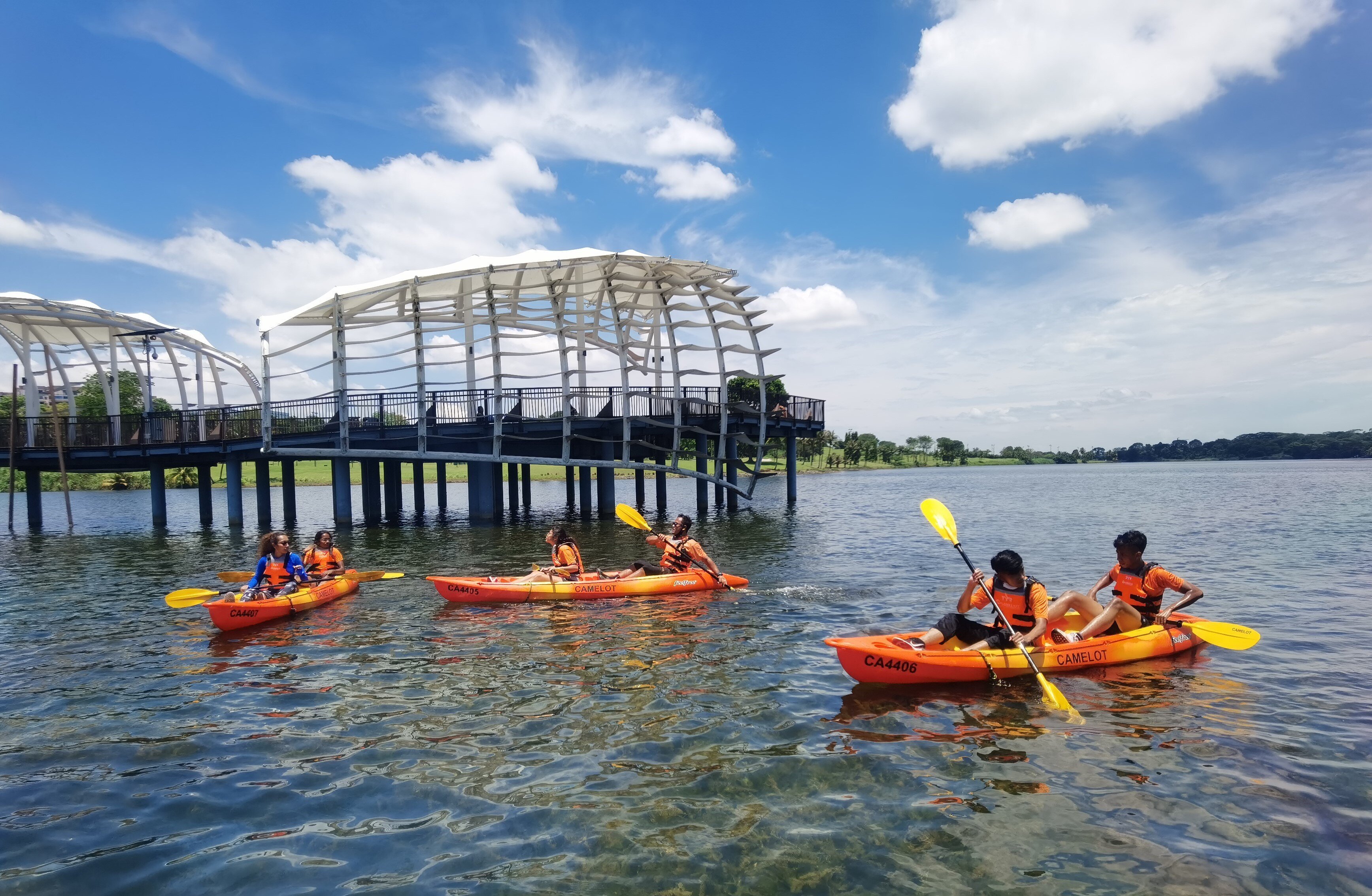 3 boats of paddlers kayaking through the waters